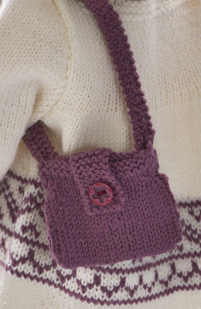 Un joli petit sac à bandoulière tricoté en lilas est parfait pour cette tenue. Il est boutonné sur le devant.