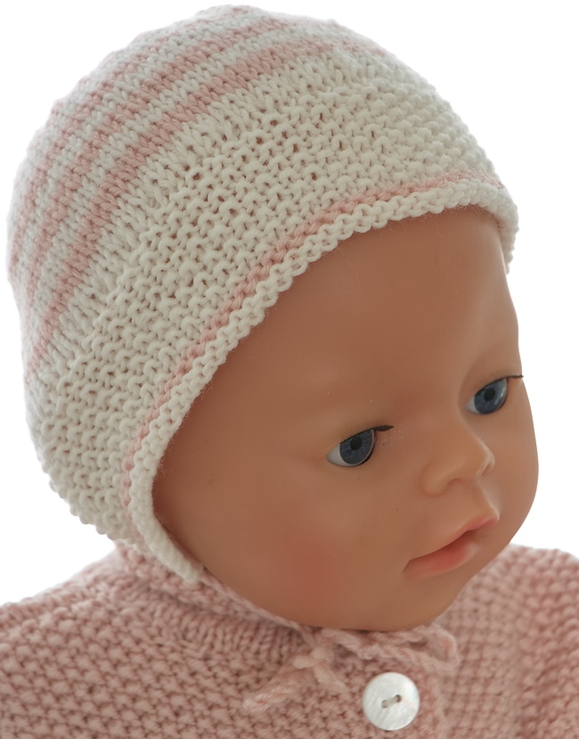 A cute bonnet and socks knitted in pink and white work out perfectly as accessories to the baby suit.