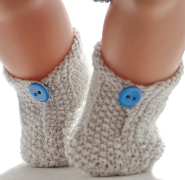 At last, your doll will get a pair of lovely grey shoes buttoned with a small blue button.