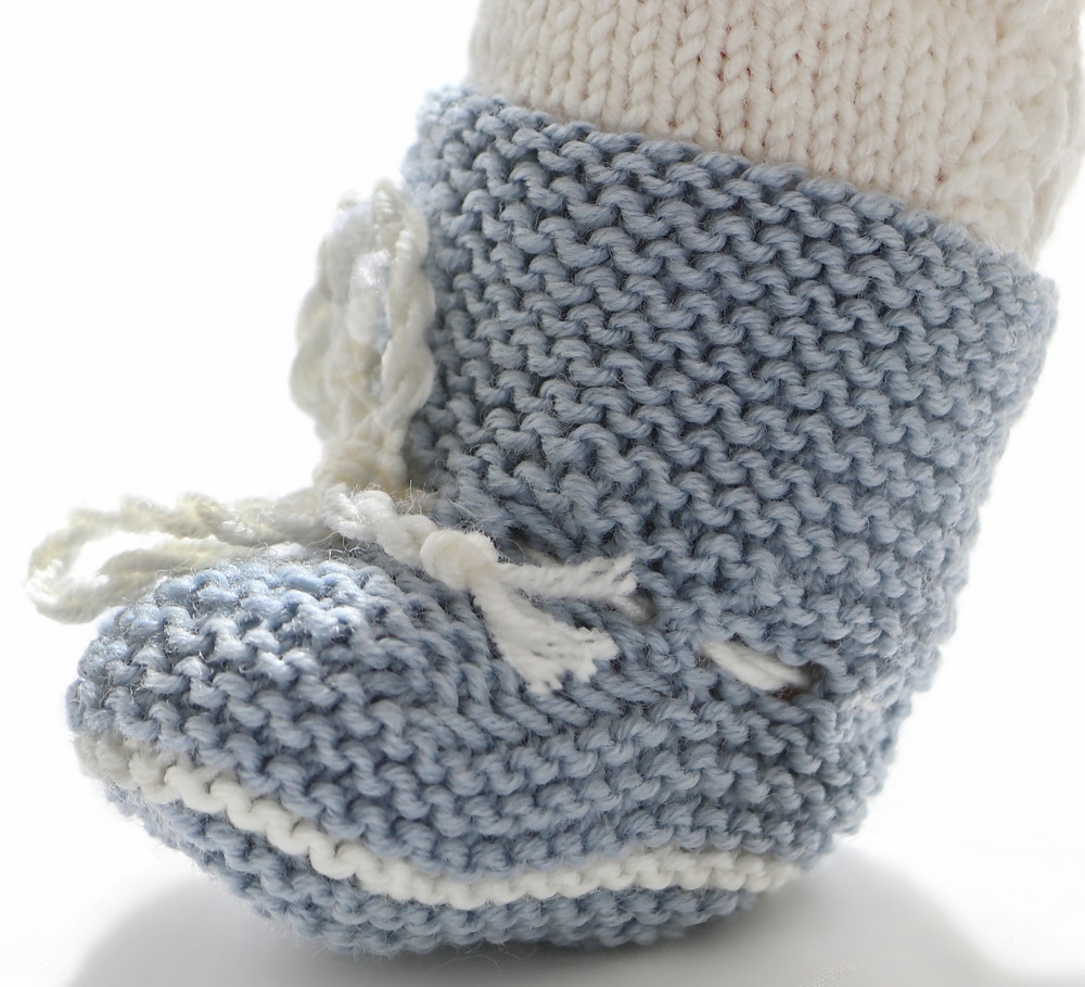 Both dolls have shoes knitted in white for the AG doll and grey for Baby born