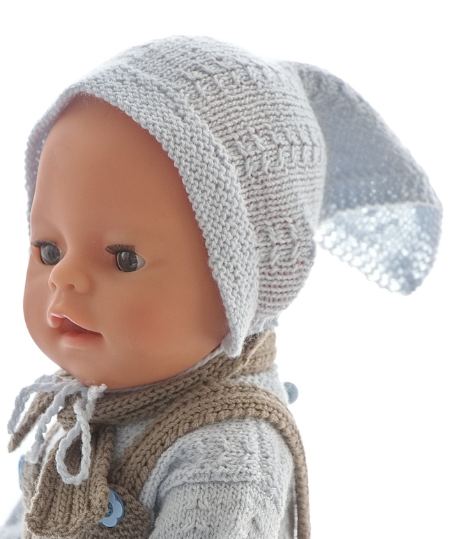 Es hat das gleiche niedliche Muster wie am Pullover. Die Ränder werden kraus gestrickt.