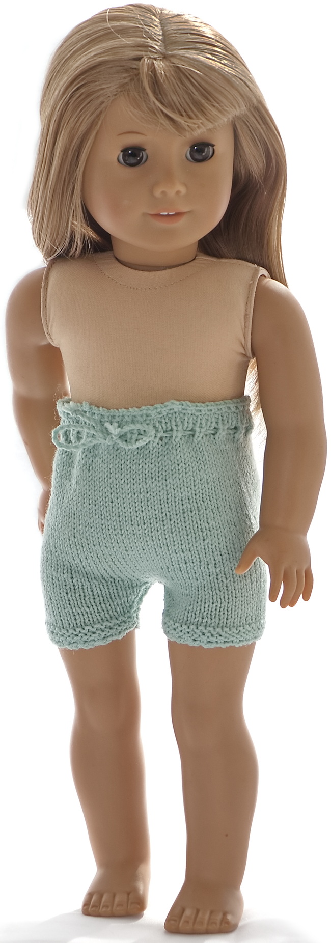 Simple pants knitted in turquoise have crocheted edges and a cord bound around the waist.