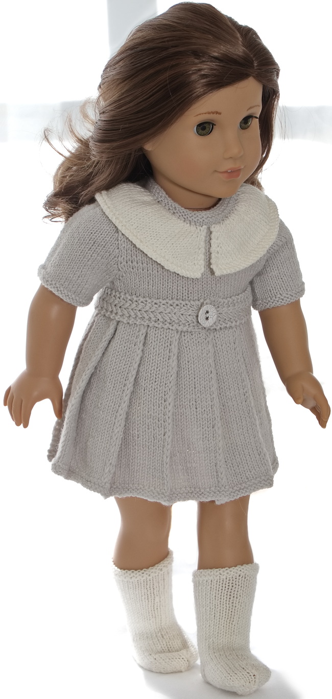 The dress has a folded skirt. It is short-sleeved and buttoned back. Around the waist, the dress has a beautiful belt knitted in a pattern.