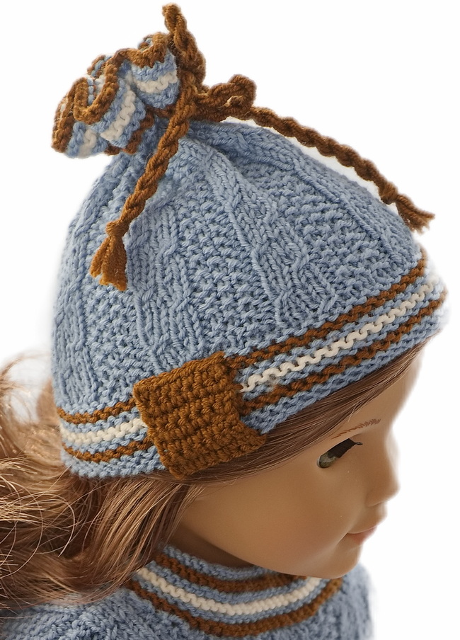 You will also find a lovely and warm cap. The cap is knitted in the same pattern as knitted for the sweater. The cap, as well, has edges knitted in stripes. A thick brown cord is pulled through the eyelets and bound together in a bow on the top of the cap.