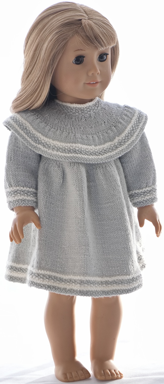 This delicate and beautiful dress is knitted in soft, light grey wool and looks great dressed on the doll. Edges are knitted in moss sts with beautiful white ridges knitted in. Light grey together with white looks often elegant and stylish.