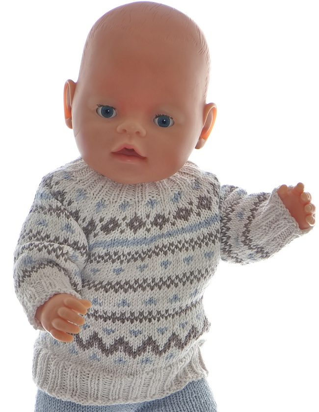 The sweater is knitted in white and has a beautiful pattern knitted in brown and grey. The edges are white and knitted in rib